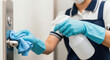 © Thanura - Closeup shot of women cleaning a door nob with a bloth using cleaning liquid