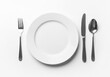 © UniqueStore - Top down studio shot of white plate with fork knife and spoon ceramic