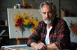 © starush - A mature male artist with gray hair and beard working in his studio surrounded by colorful abstract paintings