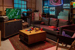 © pressmaster - Living room scene showing television displaying American football game, snacks and drinks on coffee table, empty sofa, sports memorabilia and neon lights in background, no people visible