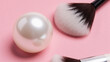 © Tina - Pearl and makeup brushed on a pink background, beauty concept