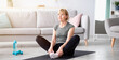 © Prostock-studio - Full length portrait of athletic mature woman stretching her legs, sitting in butterfly yoga pose on mat indoors, free space. Lovely senior lady keeping flexible, working out during coronavirus