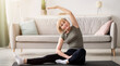 © Prostock-studio - Full length portrait of athletic mature woman stretching her leg on yoga mat in living room, copy space. Fit senior lady keeping flexible, taking care of her body, leading healthy lifestyle