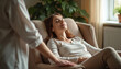© Vadym - Woman experiences mental healing through hypnosis in relaxing therapy session with professional therapist. Seated comfortably, eyes closed, appearing calm, at peace. Scene suggests supportive