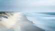 © Chookeit - Minimalist coastal landscape with long exposure effect, showing soft ocean waves blending into the sandy shore under a hazy sky, ideal for backgrounds, nature themes, and calming design visuals