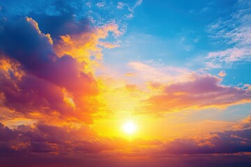 Wall Mural - Vibrant sunset sky with golden sun illuminating colorful clouds transitioning from deep orange to soft purple against a bright blue sky
