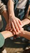 © ba - Group of people stacking hands together in unity and teamwork