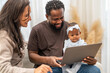 © Art_Photo - African love family happy time at home, father showing baby a laptop with cartoons for early childhood learning and development, mother smiling engaging in digital parenting and interactive education