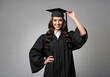 © STM Lab - Happy graduate woman in cap and gown celebrating academic achievement