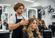 © STM Lab - Hairdresser styling clients long blonde hair in modern salon