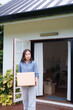© snowing12 - Asian adult woman moves box home relocation journey. Homeowner new residence transition personal belongings. Property transfer house moving.