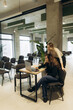 © Roman - Two Women Collaborating on a Project in a Modern Office Environment