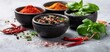 © Daryna - The colorful spices and herbs beautifully arranged in black bowls.