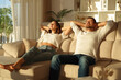 © Antonioguillem - Happy couple relaxing on a couch at sunset at home