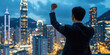 © Da - Triumphant Asian Businessman Atop Mountain: Symbol of Success and Determination. Urban Skyline Backdrop Illustrates Career Achievement and Leadership. Perfect for Business Motivation, Corporate Brandi