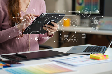 female coder or developer working using a computer display and smartphone in problem solving at work
