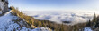 © Travel 'n' Lifestyle - View of a snowy mountain edge with a trail overlooking a sea of clouds and lush forests, a breathtaking vista, Graz, Styria, Austria.