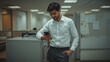 © pixindia1 - Young Indian Businessman Checking Phone During Office Break