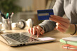 © PheelingsMedia - Student hands paying online in the night at home