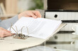 © PheelingsMedia - Woman hand organizing document in ring binder