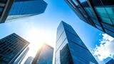 Modern corporate skyline with reflective high-rises viewed from below. Clean architecture and dynamic urban scene on a sunny day.