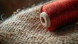 © leymart - Close-up of red thread and needle on burlap