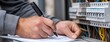 © pvl0707 - Technician inspecting electrical panel and documenting findings in a utility room during afternoon hours