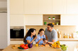 © BGStock72 - Family bonding over breakfast in a bright modern kitchen