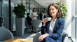 © GS-Studio - A woman takes a break in a modern office, holding a cup of coffee with people in the background. She exudes confidence and a calm, collected demeanor. The bright, open space enhances the scene