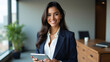 © the - Smiling Young Woman in Black Blazer Holding Digital Tablet – Modern Office Portrait