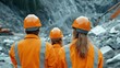 © Nuth - Engineer civil innovation Concept. Three construction workers in orange helmets observe a rocky site.