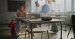 © Framestock - Exhausted Female Teacher Rubbing her Temples, Sitting Alone at Desk in Empty Classroom, Having Rest After Lesson. Woman Feeling Stress, Burnout and Emotional Struggle, Working in Modern Primary School