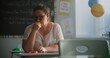 © Framestock - Tired Female Teacher Sitting Alone at the Desk in Empty Classroom, Relaxing After Class. Woman Feeling Stress, Burnout and Mental Exhaustion in Educational Environment, Working in Elementary School.
