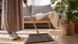 © Mahmud - Woman actively sweeping the floor with a broom — routine household chore.