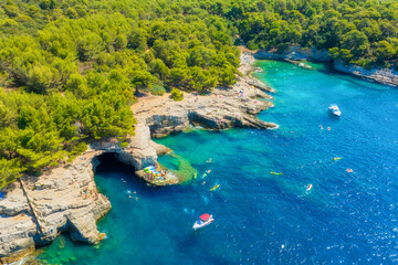 Wall Mural - aerial view on coast with rocks and forest. boats and kayaks in the bay. vacation and relax at the s