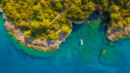 Wall Mural - aerial view on coast with rocks and forest. boat in the bay. vacation and relax at the summertime. b