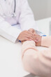 © Jo Panuwat D - doctor holding hands with elderly female patient, showing empathy and support during a medical consultation. trust, Senior and geriatric care, healthcare, Mental Health, giving advice and emotional
