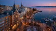 © DAVA - Panoramic cityscape at dawn, lakefront town with illuminated buildings, tranquil harbor