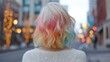 © nur khayati w - Back view of a woman with colorful, wavy hair in a city street