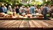 © rin.id - Rustic Wooden Table with Blurry Outdoor Garden Party and Warm Bokeh Lights