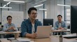 © James - Smiling Asian Man Working on Laptop in Modern Office with Colleagues