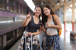 © Phimwilai - Tourists consulting smartphone and pointing at train station