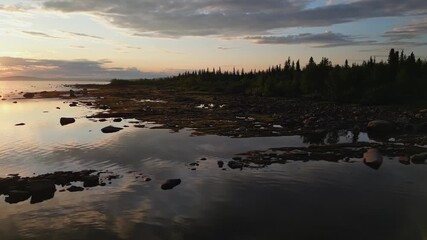 Wall Mural - drone shot of a stunning sunset over a coastline on the stora lulevatten, norrbotten county, sweden
