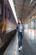 © Phimwilai - Tourist walking on train station platform after arrival