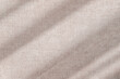 © Viktoriia - Abstract sunlight shadows on a neutral taupe beige velure cloth, aesthetic minimalist natural background with copy space