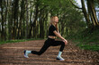 © dsheremeta - Woman stretching in forest for outdoor exercise