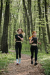 © dsheremeta - Two women jogging on a forest trail