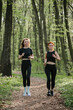 © dsheremeta - Women jogging on a forest trail for fitness