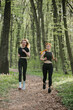 © dsheremeta - Women jogging through a serene forest path