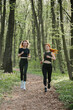 © dsheremeta - Women jogging on a forest trail for fitness